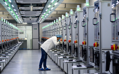 Technician inspecting lab grown diamond production equipment inside a modern diamond growing facility
